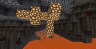 Glowstone blocks hanging down in the Nether (Image via Minecraft)